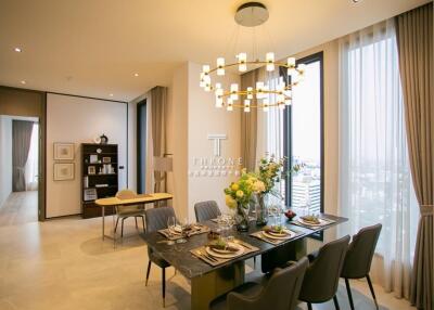 Elegant dining room with a modern chandelier and large windows