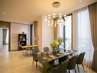 Elegant dining room with a modern chandelier and large windows