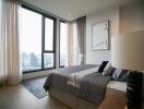 Modern high-rise bedroom with large windows and city view