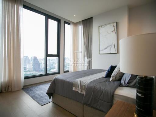 Modern high-rise bedroom with large windows and city view