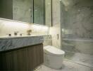 Modern bathroom with marble walls, large mirror, and glass-enclosed shower