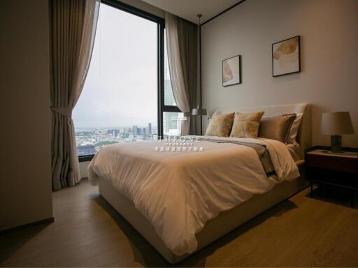 Cozy bedroom with large window and city view