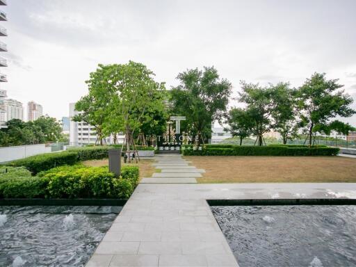 Rooftop garden with pathway and water features