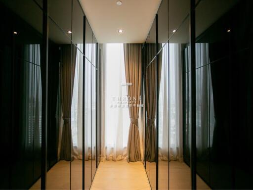 Spacious walk-in closet with floor-to-ceiling windows and ample natural light