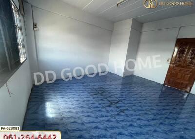 Empty room with blue tiled floor and wooden door