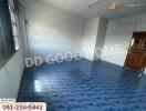 Empty room with blue tiled floor and wooden door