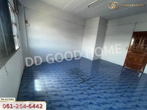 Empty room with blue tiled floor and wooden door