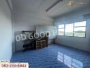 Spacious empty bedroom with blue tile flooring and large window