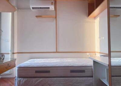 Bedroom with visible bed, air conditioner, and minimalistic design