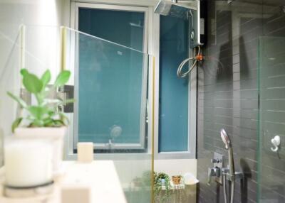 Modern bathroom with a glass shower enclosure and window
