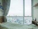 Bedroom with large window and city view