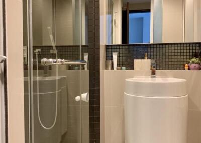 Modern bathroom with glass shower and sleek vanity