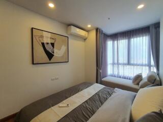 Modern bedroom with large window and air conditioning