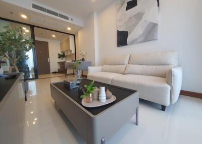 Modern living room with a white sofa, coffee table, and decor items