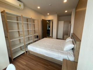 Spacious bedroom with wooden flooring and ample storage