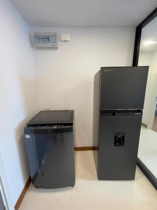 Modern kitchen area with a refrigerator and a wine cooler