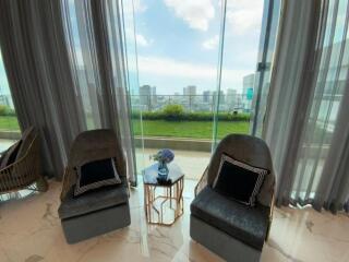 Living room with large glass windows and city view