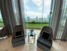 Living room with large glass windows and city view