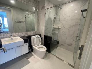 Modern bathroom with glass shower and white fixtures