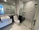 Modern bathroom with glass shower and white fixtures