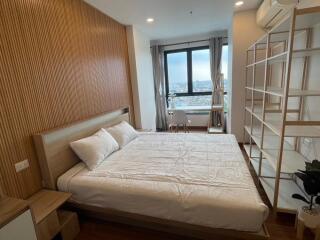 Modern bedroom with a large window and wooden decor