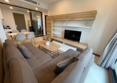 Modern living room with wooden furniture and a large sofa