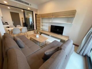 Modern living room with wooden furniture and a large sofa