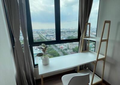 Room with desk and city view