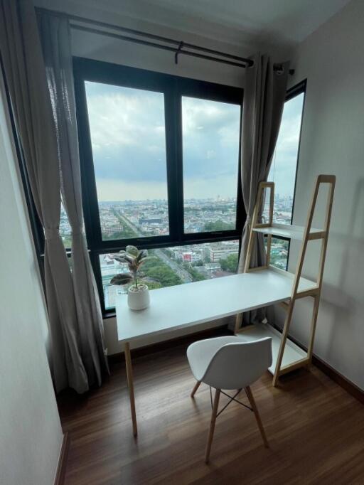 Room with desk and city view