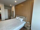 Modern bedroom with wooden accent wall and double bed