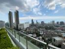 Cityscape view from a high-rise building balcony