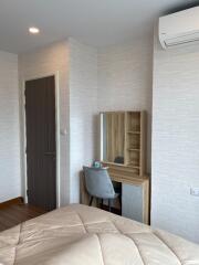 Bedroom with desk and chair, door, and air conditioner