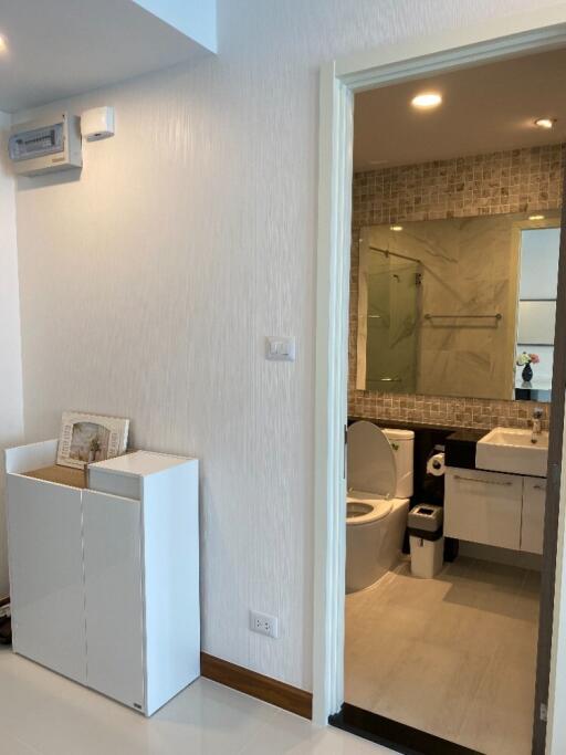 Modern bathroom with white fixtures and a glass shower