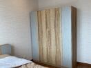 Bedroom with wooden wardrobe and bed