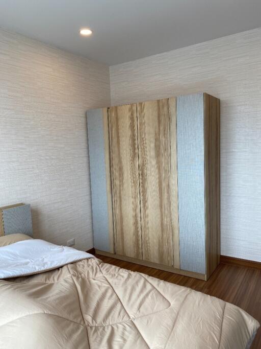 Bedroom with wooden wardrobe and bed