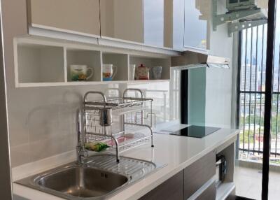 modern kitchen with built-in cabinets and city view