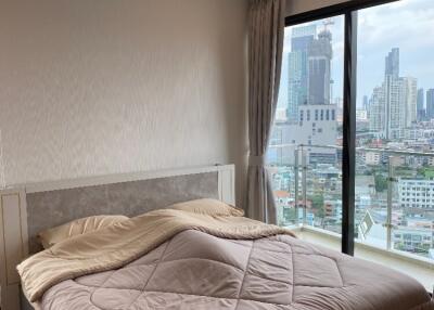 modern bedroom with large window and city view