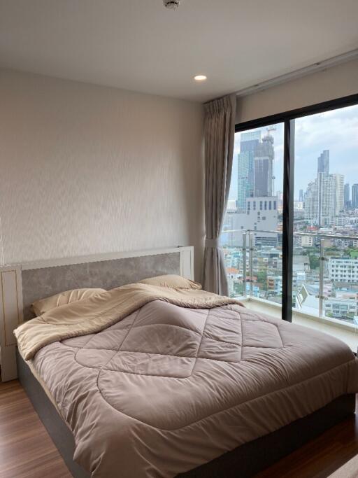 modern bedroom with large window and city view