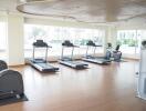 Spacious and well-lit fitness center with modern exercise equipment