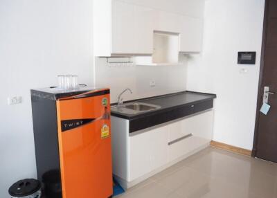 modern kitchen with orange refrigerator