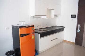 modern kitchen with orange refrigerator