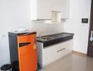 modern kitchen with orange refrigerator