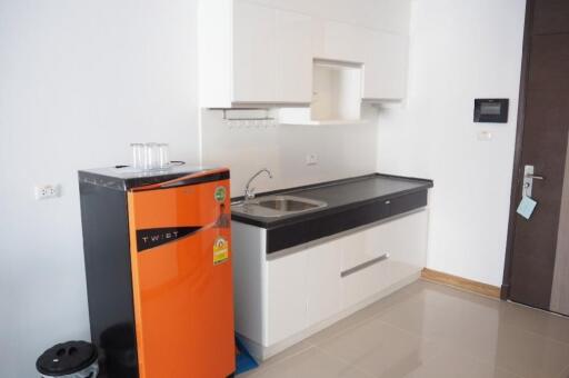 modern kitchen with orange refrigerator