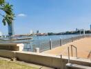 Waterfront view with city skyline and boardwalk