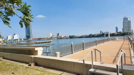 Waterfront view with city skyline and boardwalk