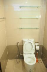 Modern bathroom with toilet and glass shelves