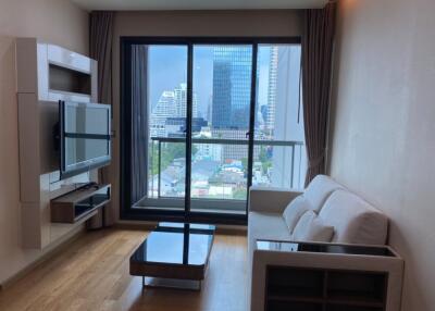 Modern living room with a large window offering a city view