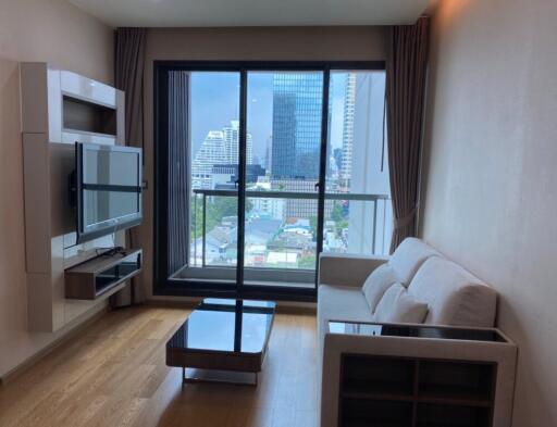 Modern living room with a large window offering a city view