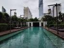 Outdoor swimming pool in a residential area with city skyline in the background