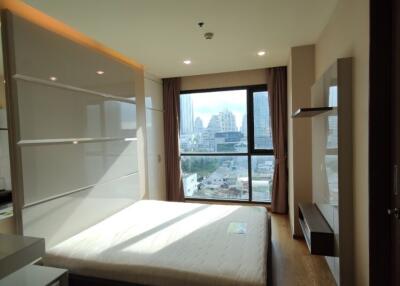 Spacious bedroom with large windows and modern furnishings